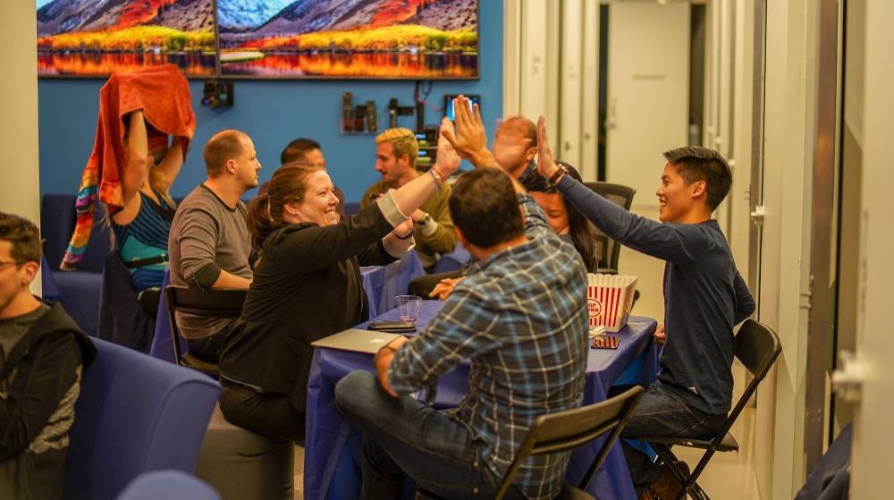 Bluecore marketing team high-fiving eachother